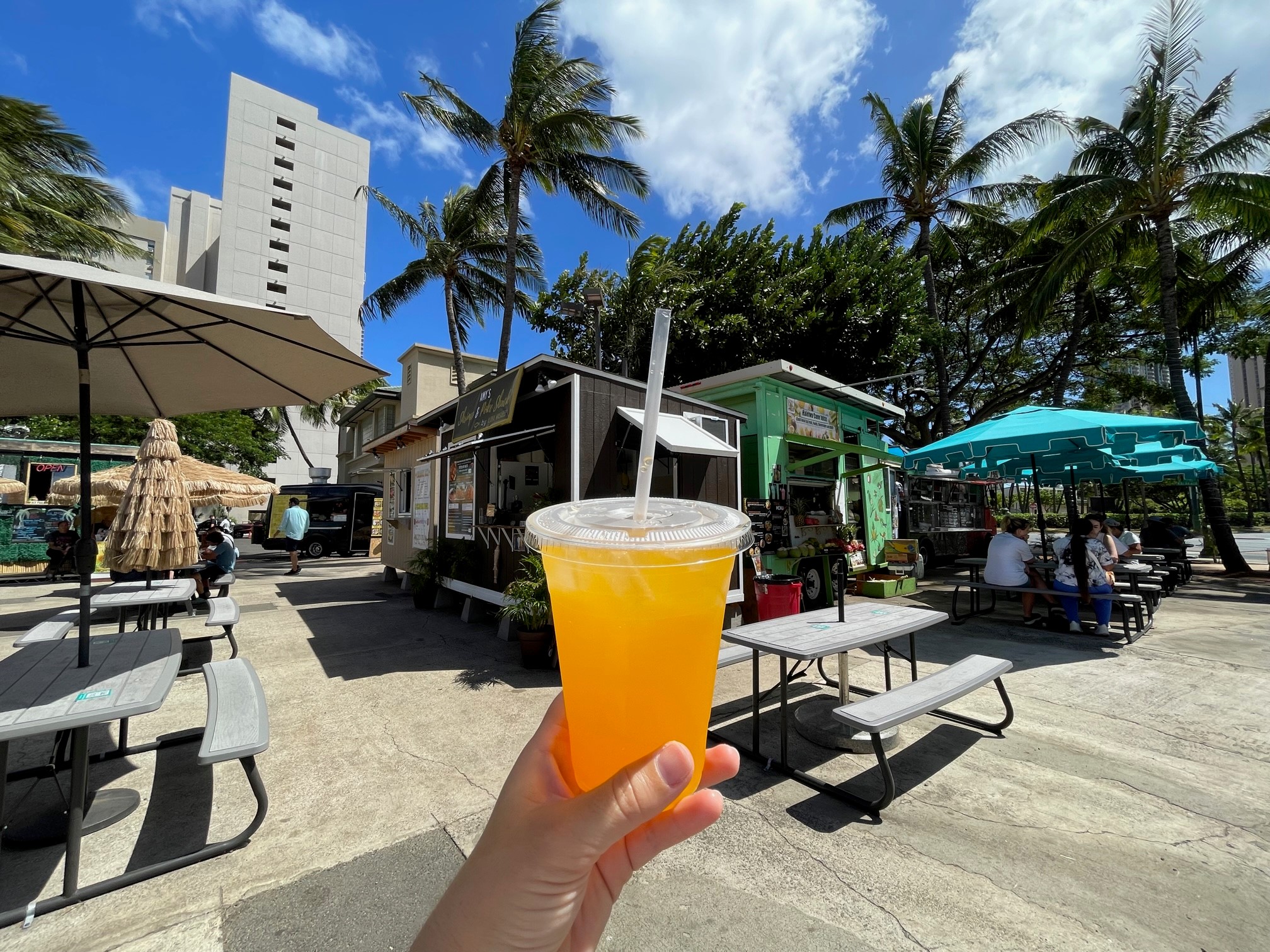 Woman holding a drink from the Ohana Hale food trucks