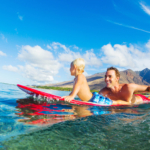 Father and Son Paddling on a Surfboard - Waikiki Beach